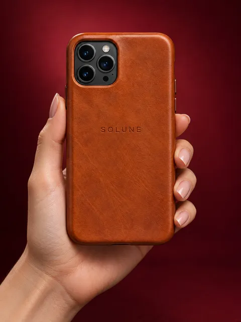 Leather phone case — held up in one hand, AI photo made with Pixo Studio